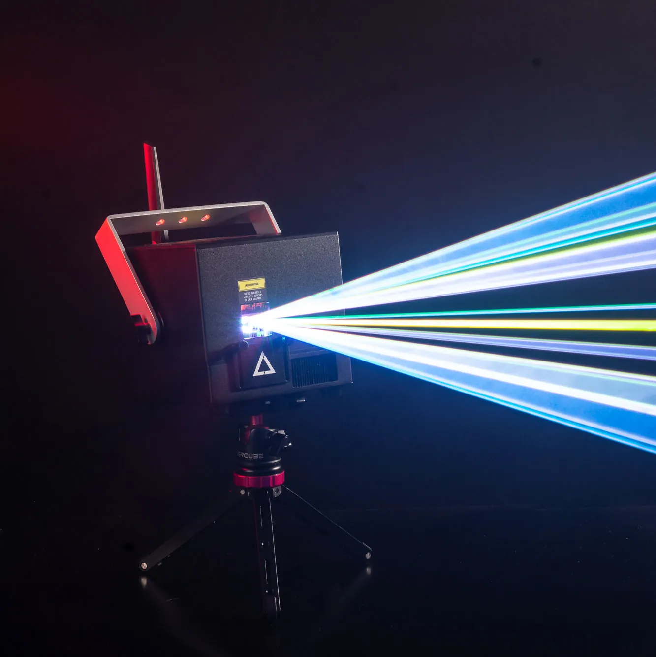 A lasercube laser light projector creating laser lights for a laser show with beams going to the right.