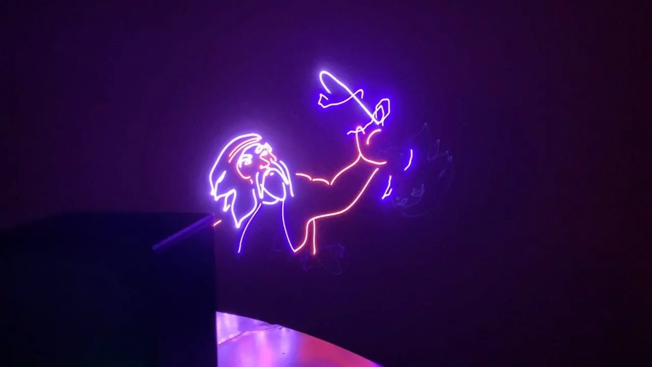 Laser animation lights created by the lasercube projector, showing the outline of an bearded man holding a sword.