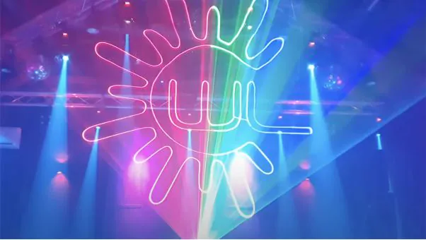 The Wicked Lasers logo drawn in laser light above a stage with beams and spotlights