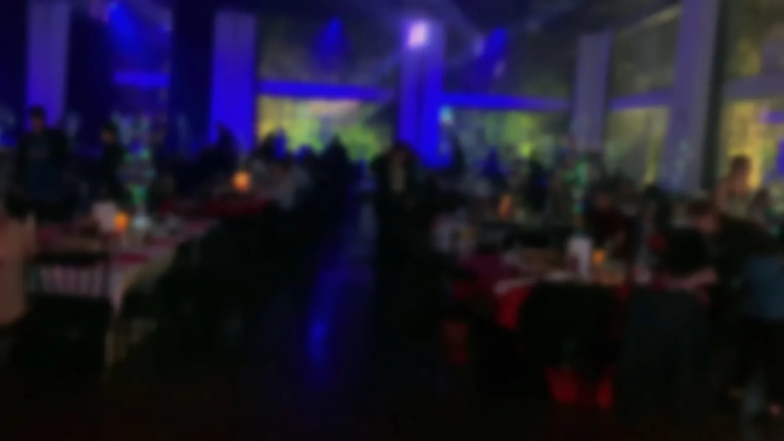 Laser lights at a dark restaurant.