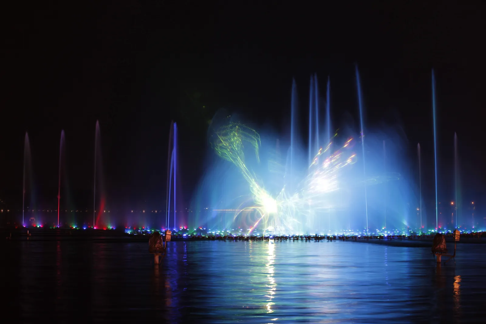 Laser images on a water screen over a lake at night