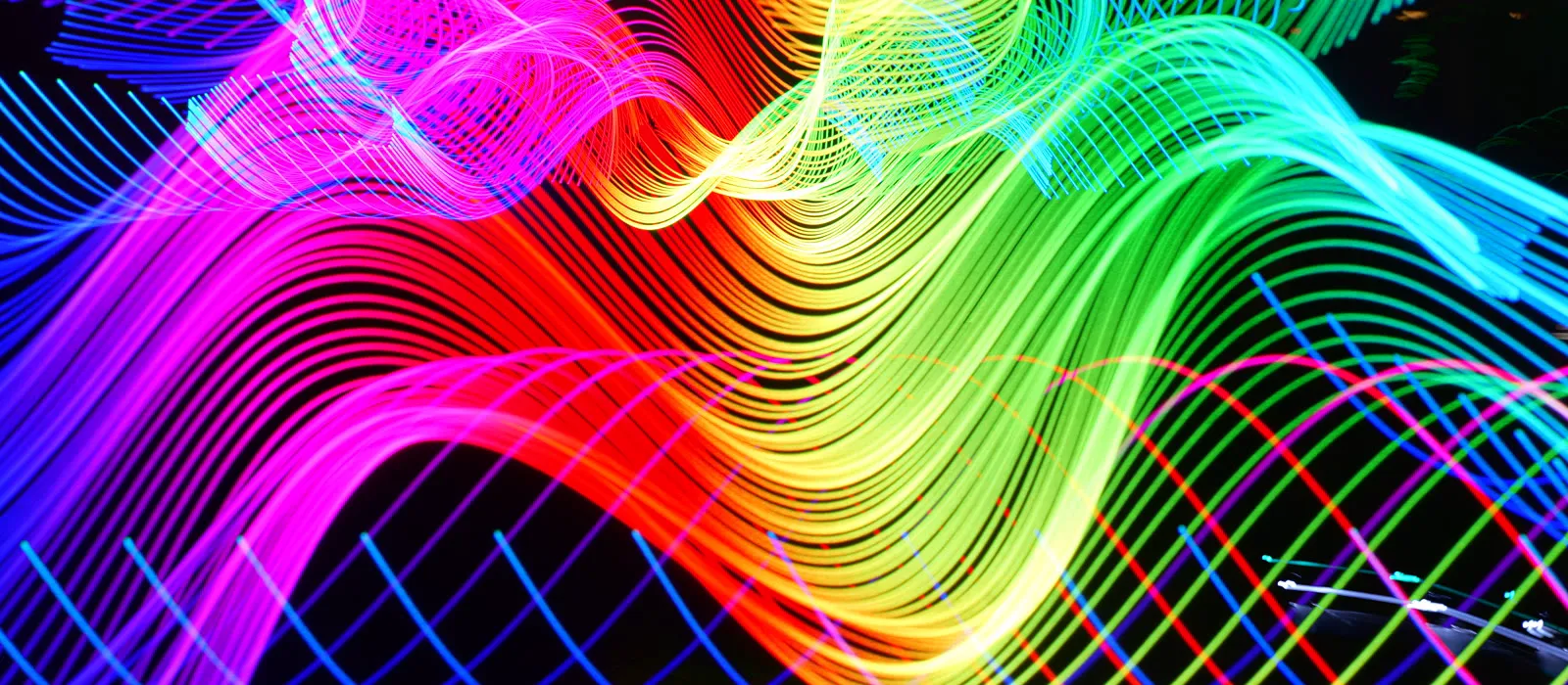 Long-exposure laser light painting in rainbow colors