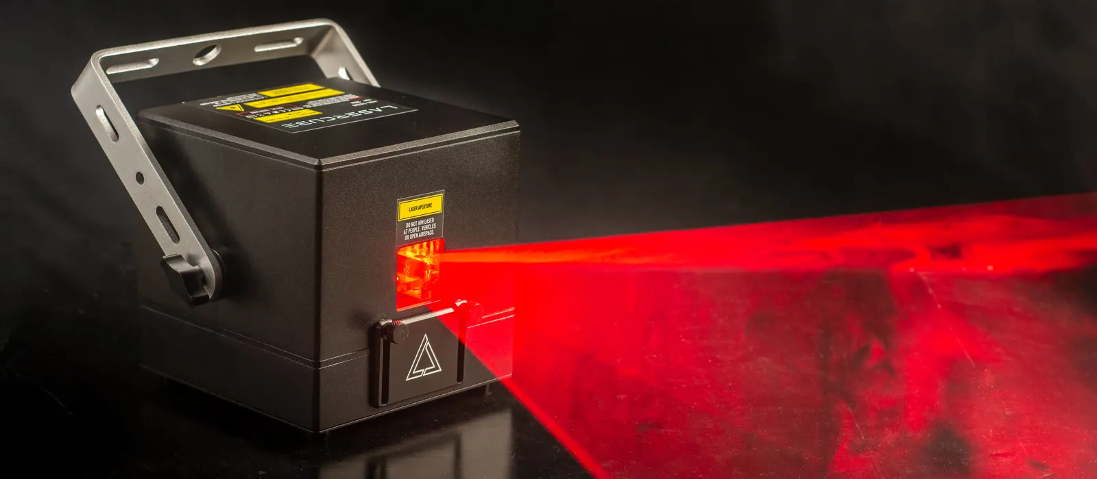 LaserCube Pro projecting a red laser fan through haze